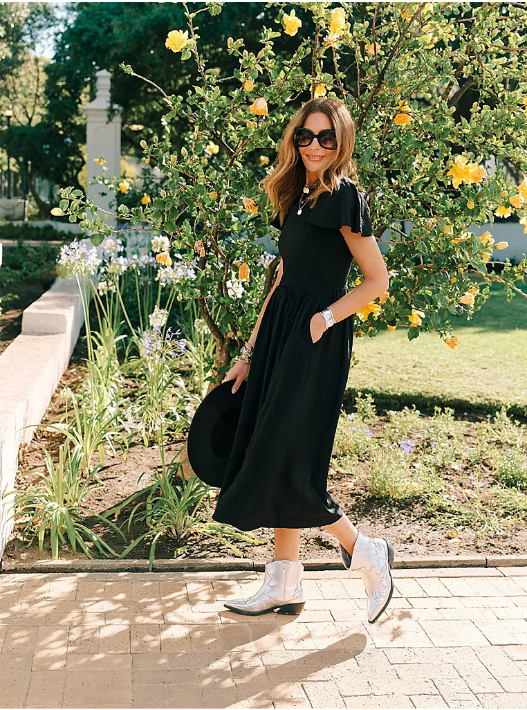 kat farmer wearing balck dress 