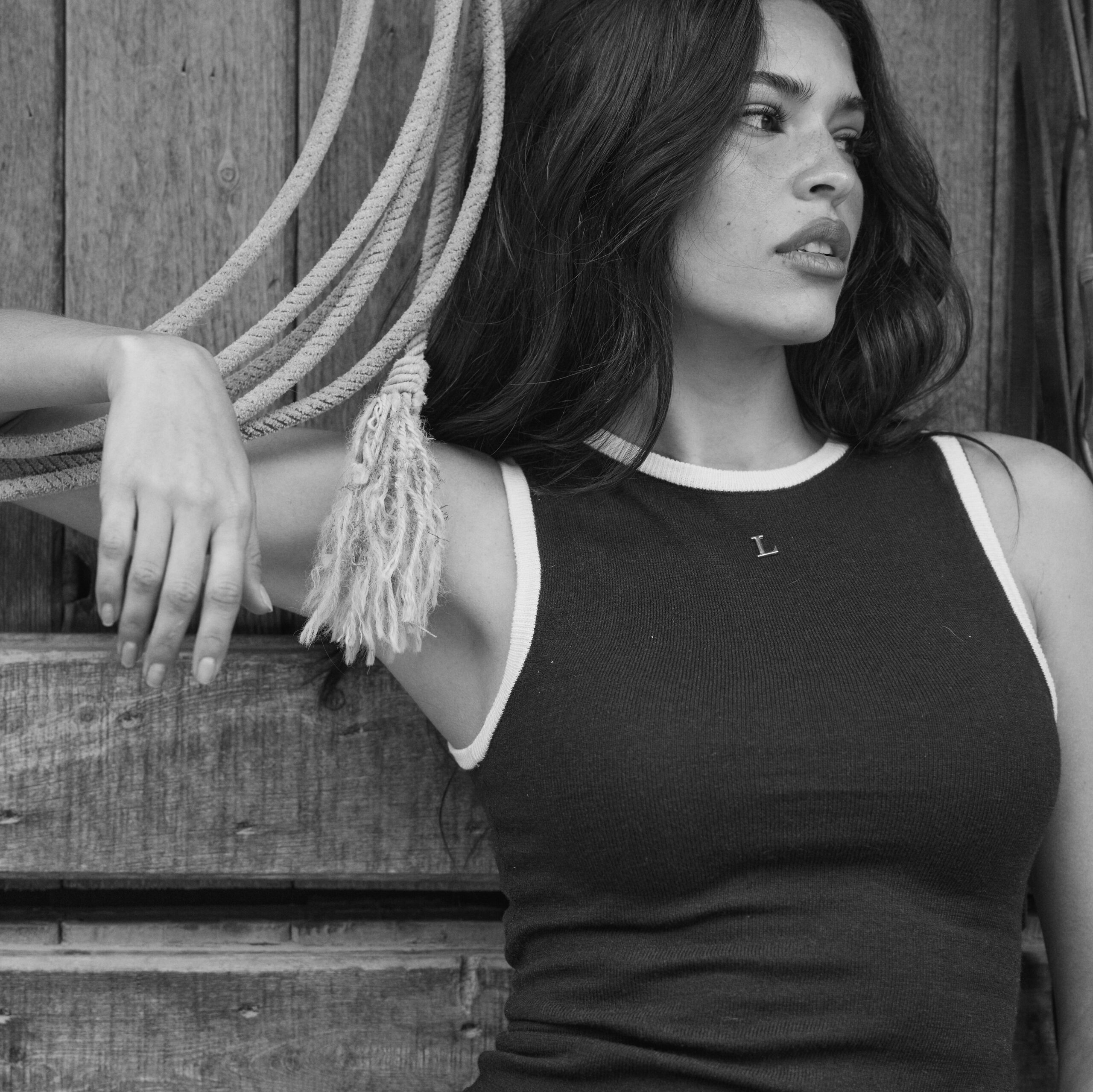 model in tack room wearing knit vest