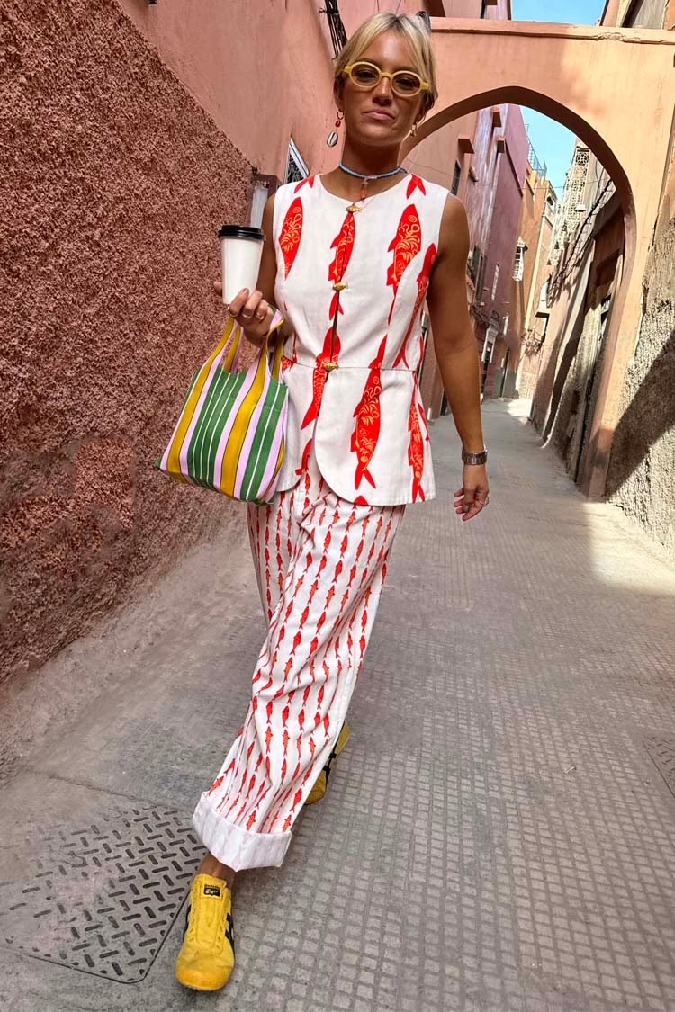 Caetana walking in strets wearing red print co-ord