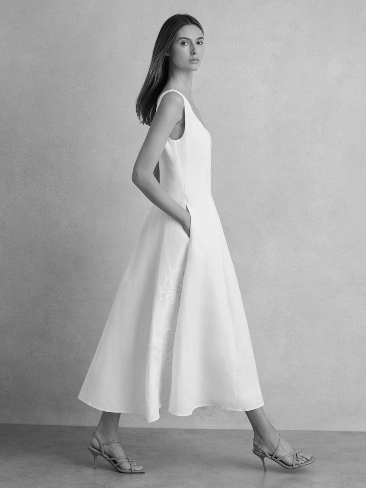 model in white midi dress 