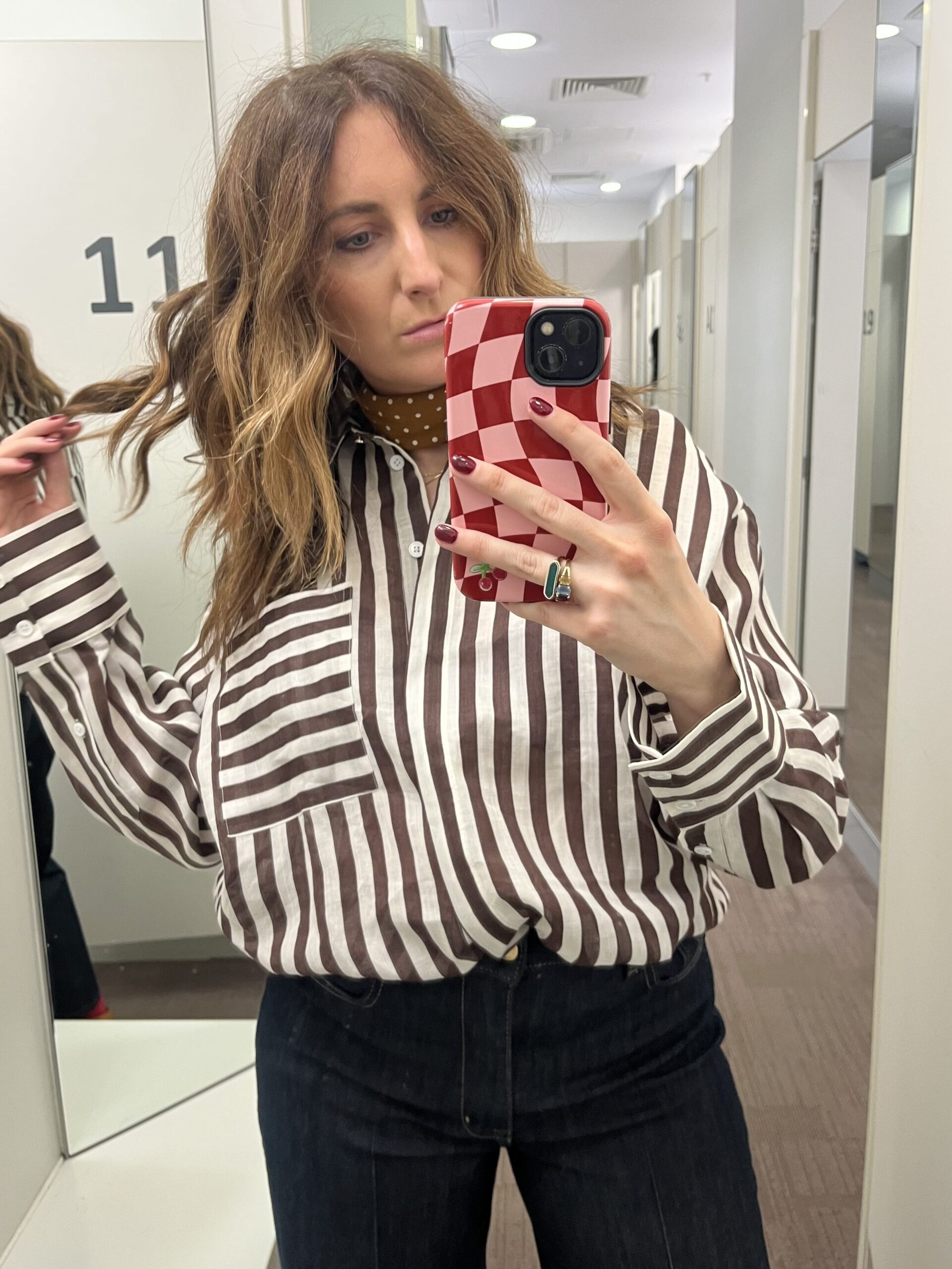 astrid in changing room wearing striped shirt 