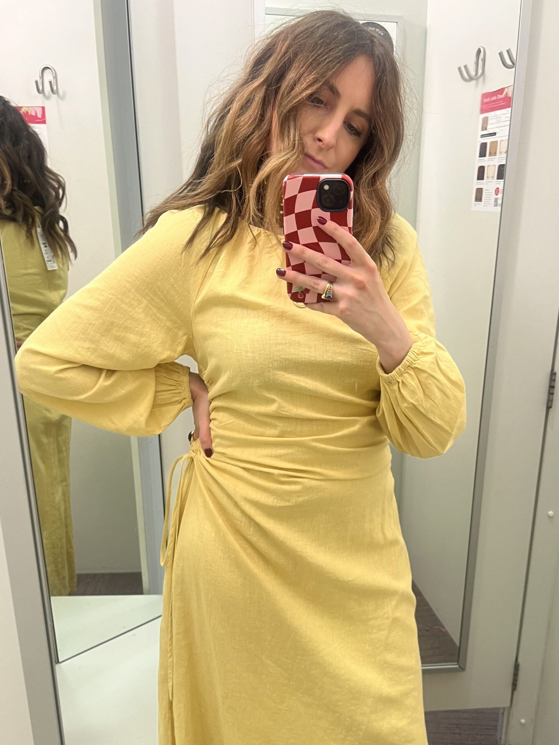 astrid in changing room wearing yellow dress 