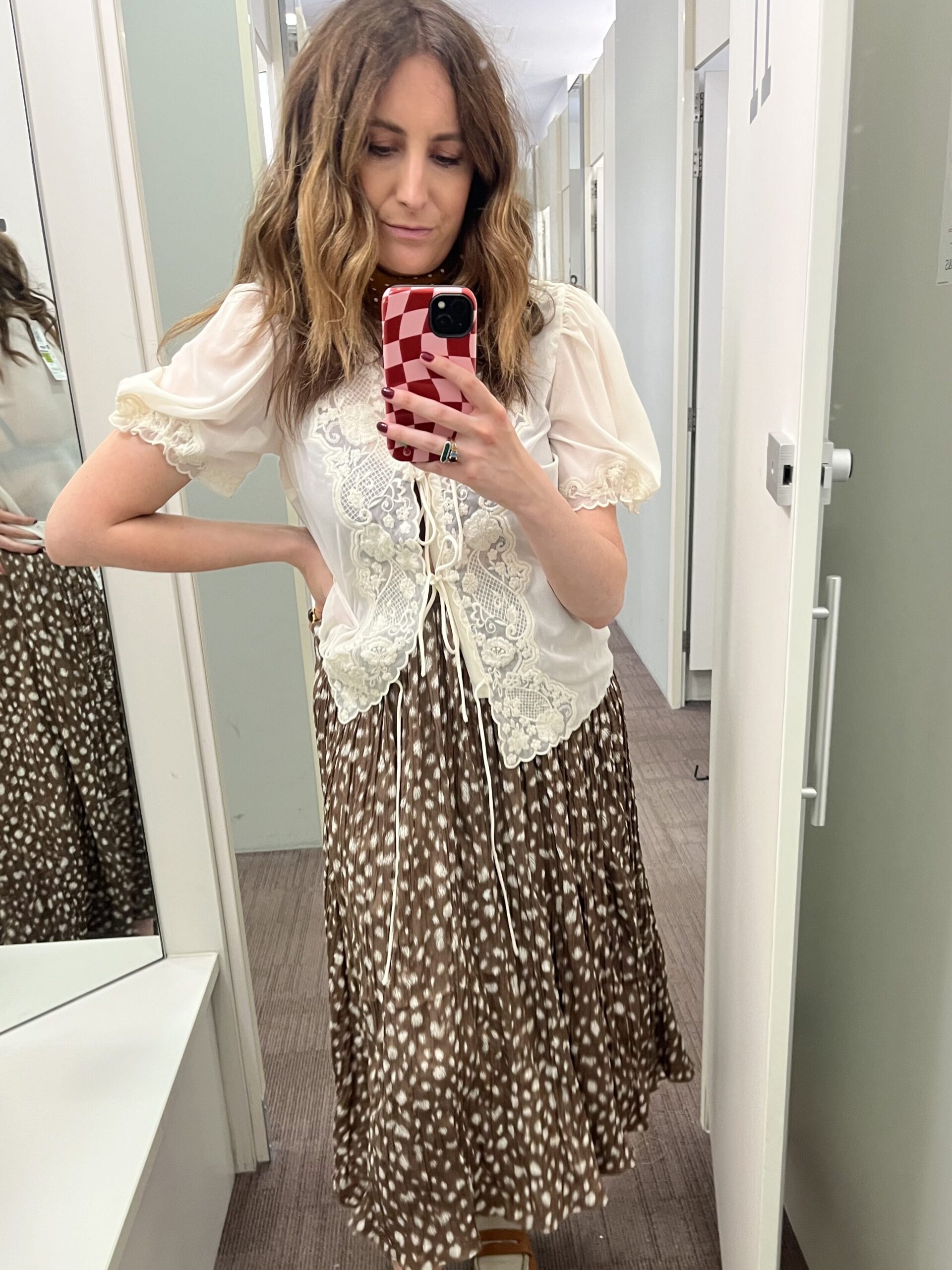 astrid in changing room wearing animal print skirt and lace top 
