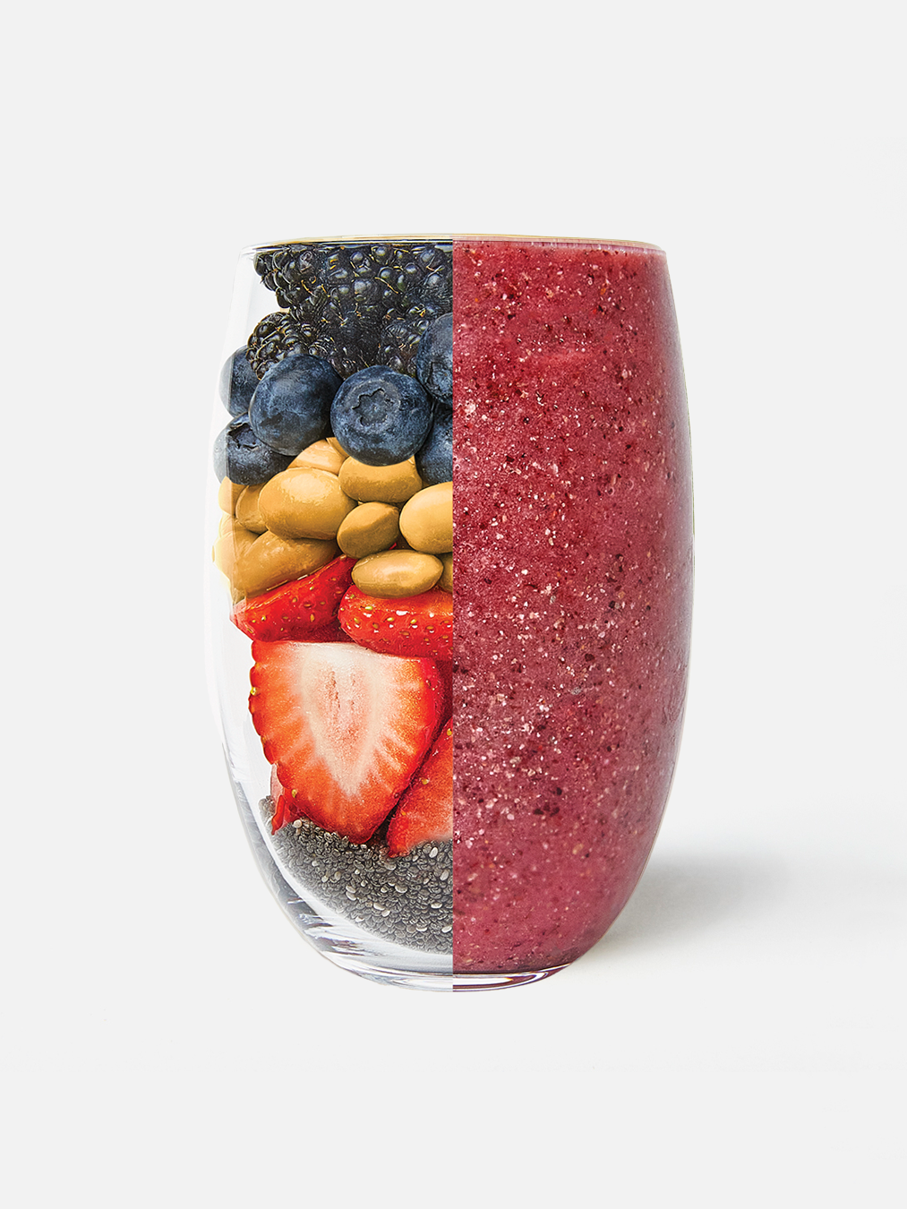 A clear glass is shown half-filled with layered ingredients—blackberries, blueberries, peanut butter, strawberries, chia seeds—from Mindful Chef, and half-filled with a blended purple smoothie made from those ingredients, against a white background.