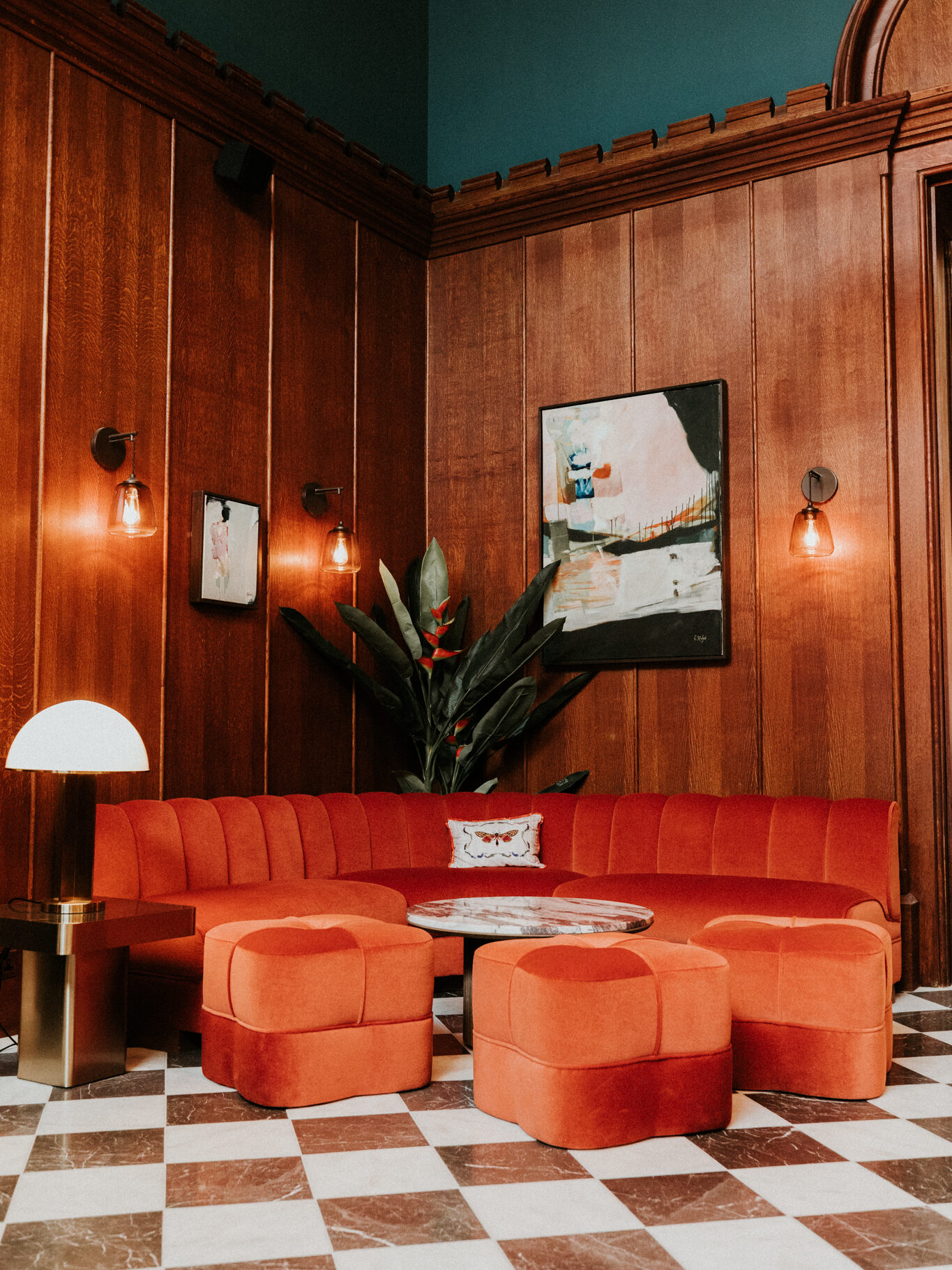 the reception area at mar hall with chequered floor and orange sofa 