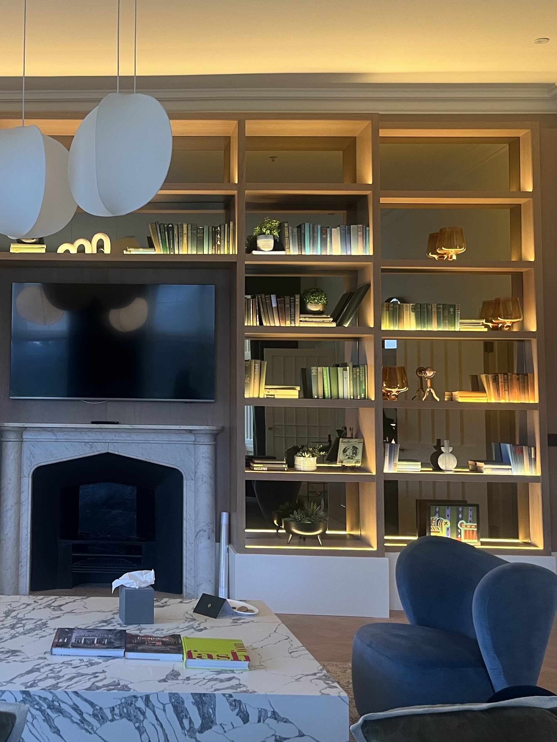 living room in suite at mar hall - floor to ceiling curated book shelves 
